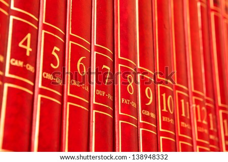 Row of red encyclopedia books on a shelf