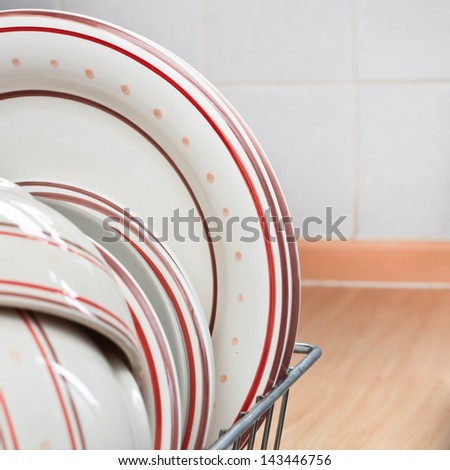 Crockery drying in a metal rack in a home kitchen