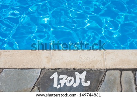 Depth notice at the edge of a swimming pool