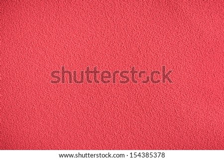Red synthetic chair covering material as a background