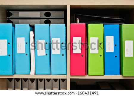 Selection of colorful box files in a home office