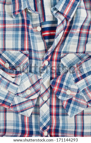 A thick man\'s shirt with checked blue,red and white pattern