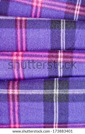 Close up of a folded tartan blanket