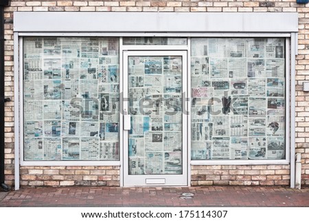 CAMBRIDGE, UK - JANUARY 25, 2014:  A closed down store on Mill Road in Cambridge, with newspaper covering the windows and door.