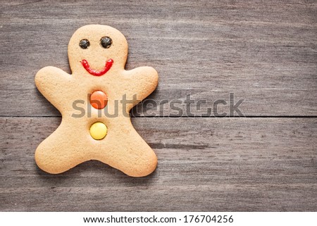 A single gingerbread man on a wooden surface