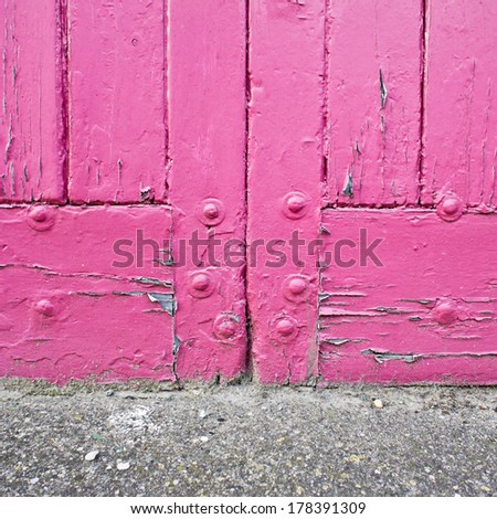 Close up of the base of a pink door