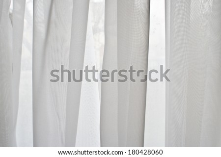 Close up of a white net curtain in detail