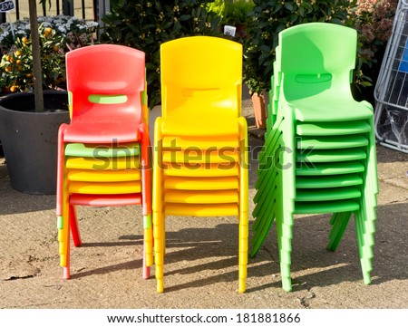 Stacks of colorful plastic children\'s chairs