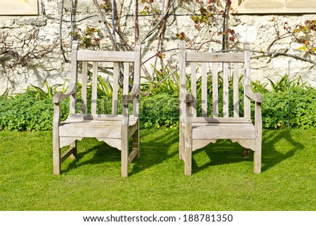 Two wooden chairs in a sunny garden