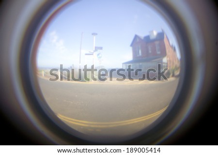 Blurry image through a fish eye glass hole in a door
