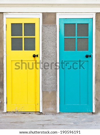 Adjacent yellow and blue closed doors