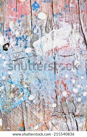 Messy blue red and white paint on a wooden surface
