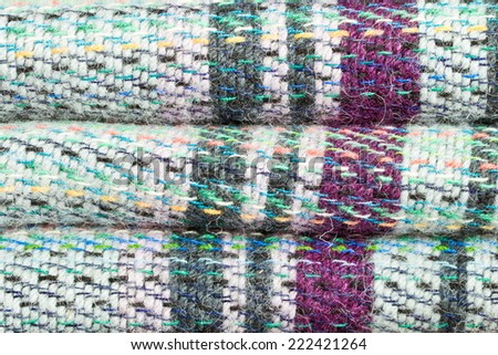 Close up of part of a folded colorful wool blanket