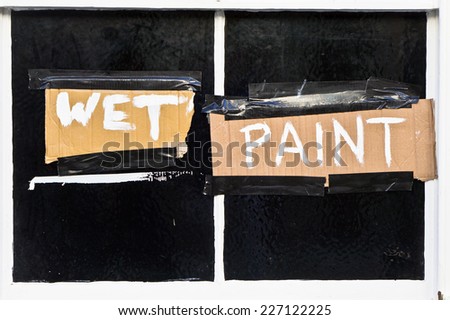 Warning sign for wet paint on a window fram?e