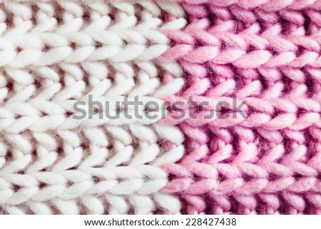 Close up of a woven wool pattern with off white and pink colours, soft focus