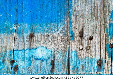 Weathered blue wood with rusty nails as a background
