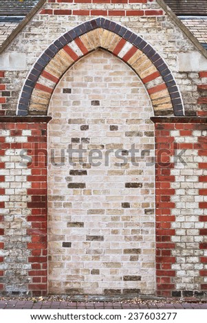 An arch shaped alcove in a brick wall