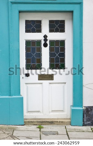 A blue framed front door in an english home