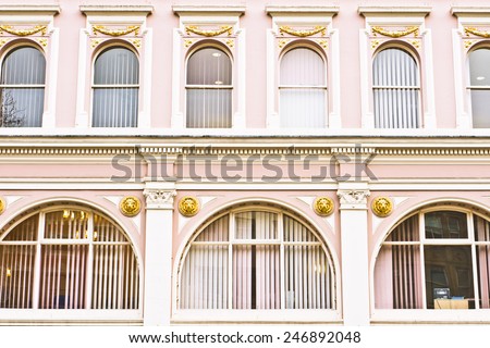 Arch windows in a pink building in the UK
