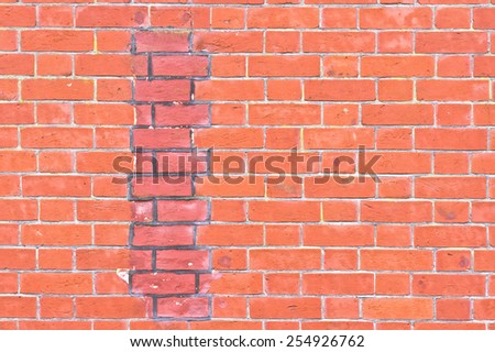 Part of a brick wall with an area of repair