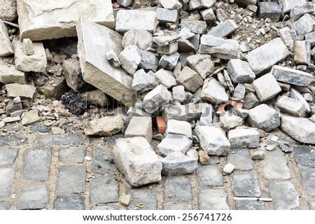 Bricks and rubble on a cobbled road