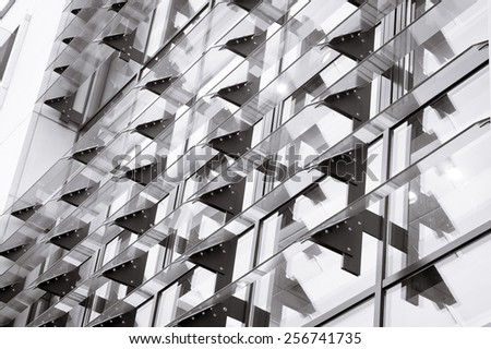 Part of a modern building with glass panels in black and white