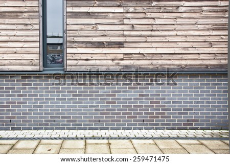 Brick and wooden wall on a modern eco building