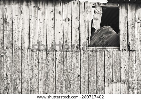 Broken side of an old wooden hut in England in black and white