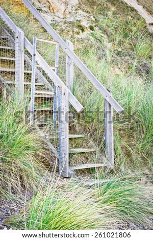Base of a flight of wooden steps at a beach in England
