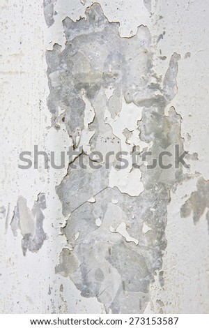 Peeling white paint on a metallic surface as a background image