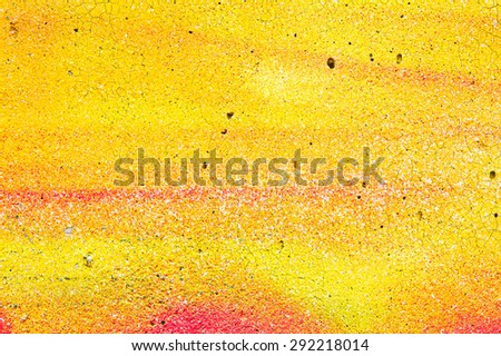 Cracked yellow and orange paint on a stone surface as a background image