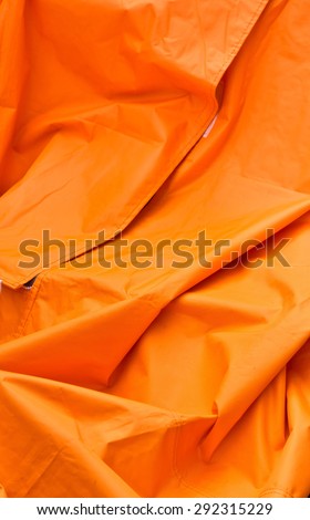 Folded orange synthetic material as a background image