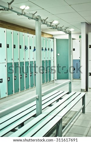 Lockers and benches in a sports centre changing room