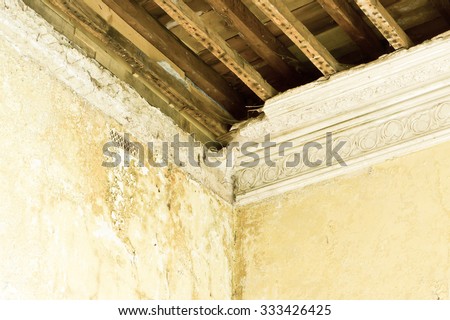 Part of a damaged interior ceiling with exposed timber