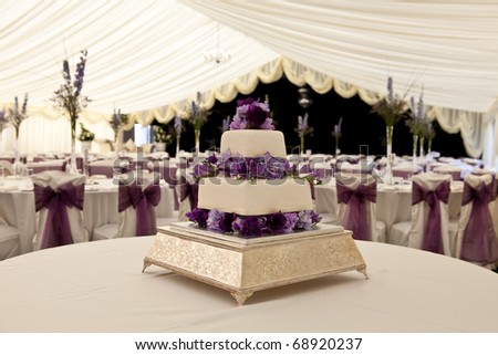 stock photo Wide angle view of a wedding cake with venue in background