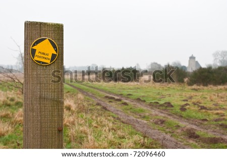 Footpath sign in England, with path as background