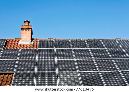 Modern solar panels on a tiled roof in the sunlight