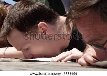 a man face down in a plate at a pie eating contest
