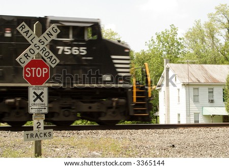 a train engine passing by a railroad crossing