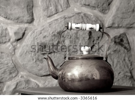 a copper tea pot in a rustic setting