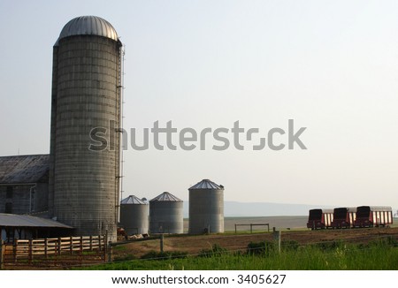a silo and grain bins on at a farm