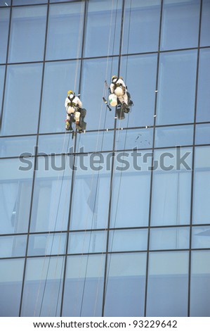 Men cleaning windows on a high rise building in Dubai