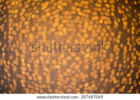 Bokeh of fairy lights hanging against a wall and out of focus to create a beautiful pattern.