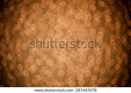 Bokeh of fairy lights hanging against a wall and out of focus to create a beautiful pattern.