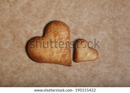 Two heart cookies on baking sheet