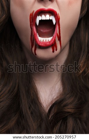 Female vampire with bloody teeth