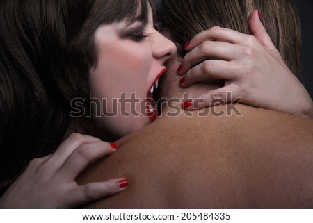 Female vampire bites man in the neck