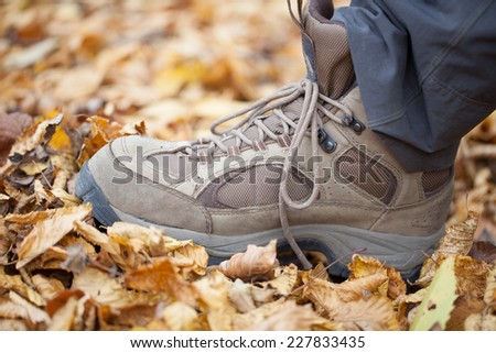 Close up of feet of a hiker walking in autumn leaves
