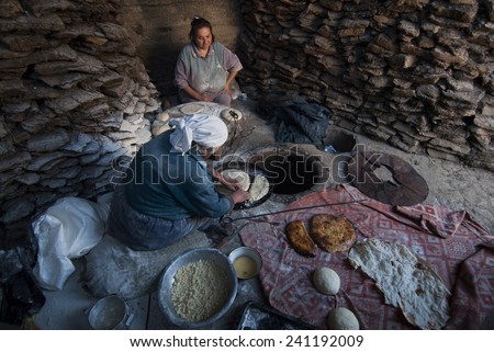 Garni, Armenia - October 9, 2011: Armenian woman baking traditional Armenian bread called \