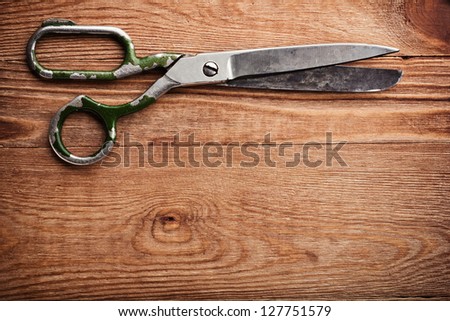 Old tailors scissors on wood background
